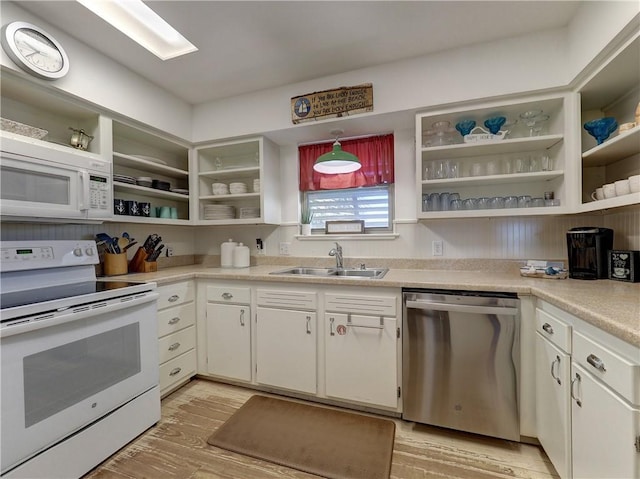 kitchen featuring light hardwood / wood-style floors, sink, white appliances, and white cabinets