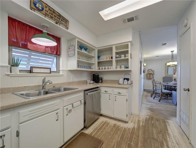 kitchen featuring white cabinetry, dishwasher, pendant lighting, light hardwood / wood-style flooring, and sink