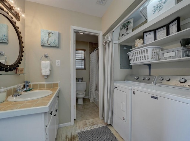 full bathroom featuring separate washer and dryer, toilet, vanity, and shower / tub combo