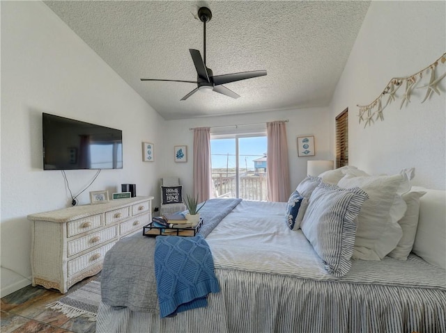 bedroom featuring ceiling fan, access to exterior, a textured ceiling, and lofted ceiling