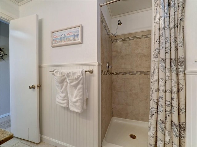 bathroom featuring a shower with shower curtain, ornamental molding, and tile patterned flooring