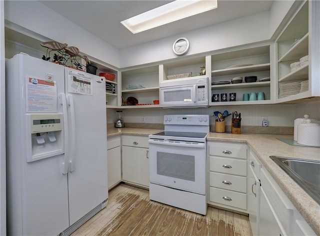 kitchen featuring light wood-type flooring, sink, white appliances, and white cabinetry