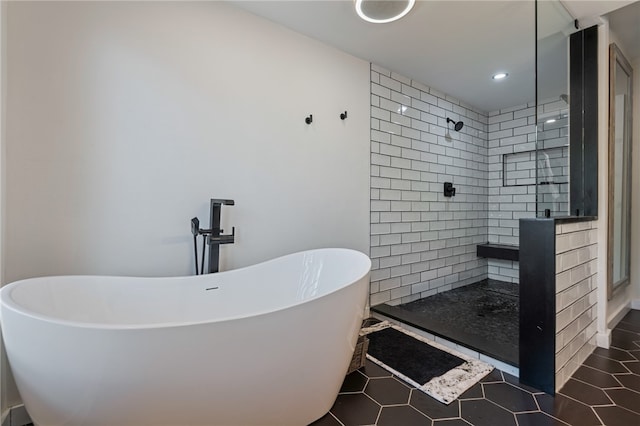 bathroom featuring tile patterned floors and separate shower and tub