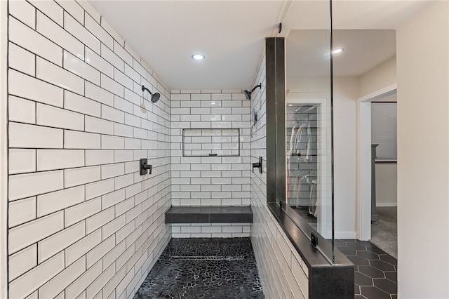 bathroom with tile patterned flooring and tiled shower