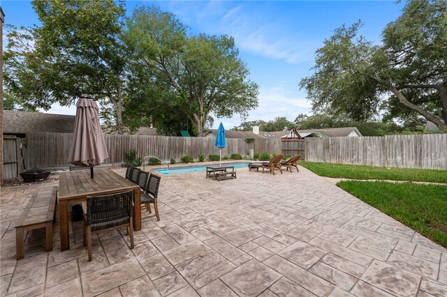 view of patio / terrace with a fenced in pool