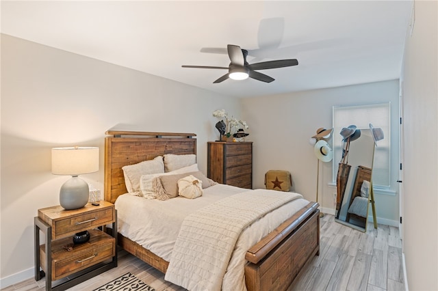 bedroom with ceiling fan and light hardwood / wood-style floors