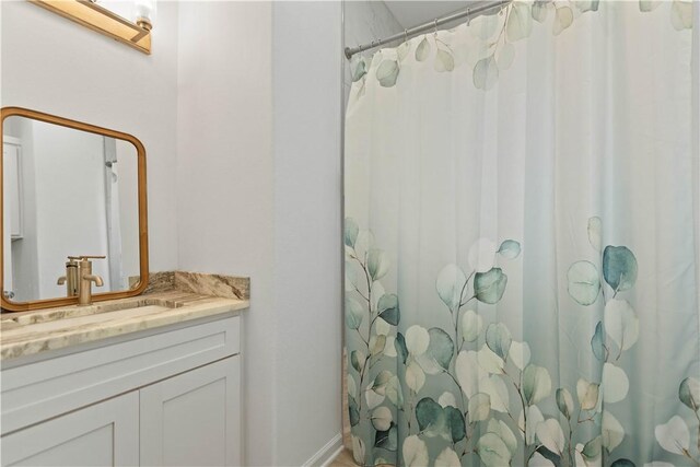 full bath with vanity and a shower with shower curtain