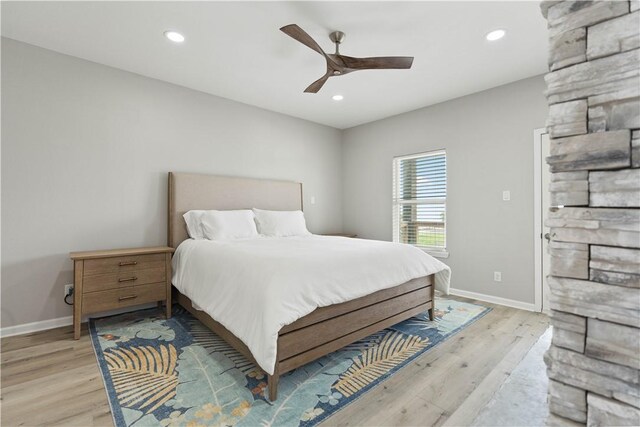 bedroom featuring baseboards, light wood-style floors, and recessed lighting