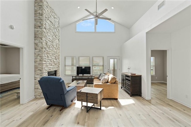 living area featuring a wealth of natural light, light wood-style flooring, and a ceiling fan
