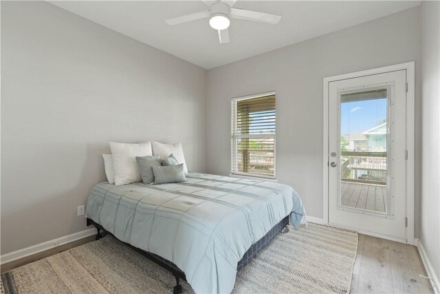 bedroom with baseboards, light wood-type flooring, and a ceiling fan