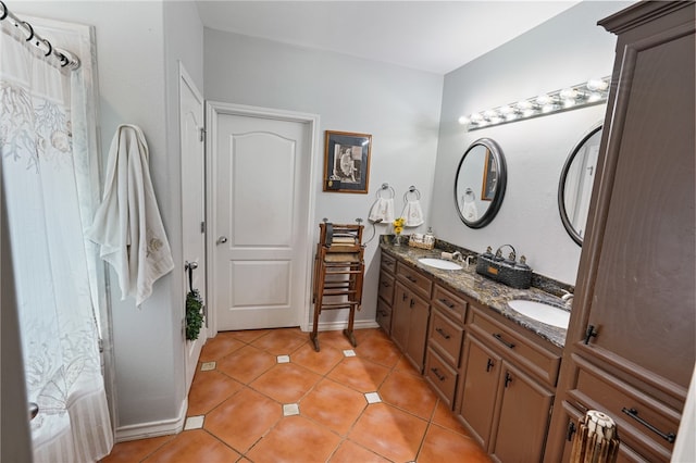 bathroom featuring tile patterned flooring and vanity