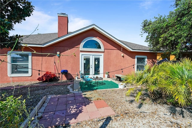 back of property with french doors and a patio