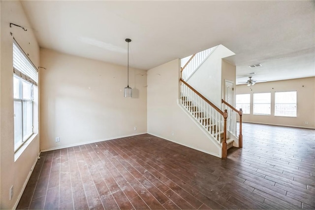 unfurnished room with ceiling fan and dark wood-type flooring