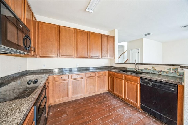 kitchen with dark hardwood / wood-style flooring, sink, and black appliances