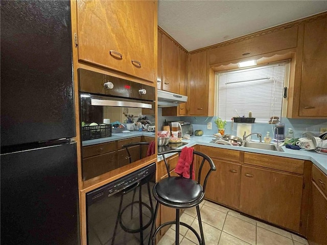 1318 Meadowlane Dr, Corpus Christi, TX 78412 - kitchen featuring black appliances, brown cabinetry, and light countertops