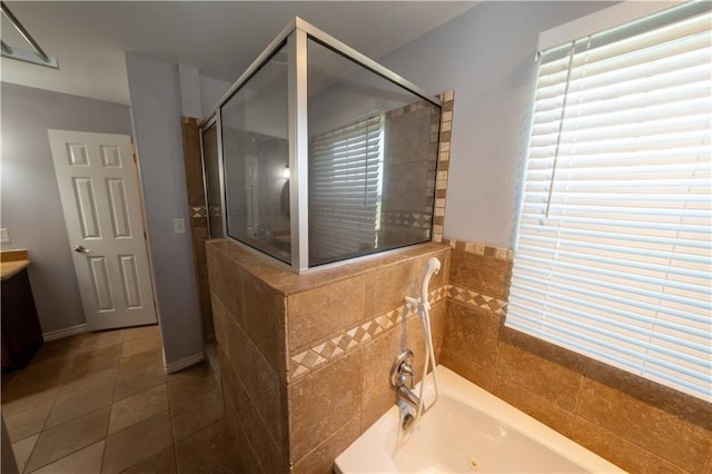 bathroom with tile patterned floors, vanity, and independent shower and bath