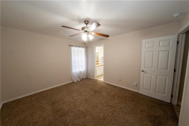 spare room featuring ceiling fan and dark carpet