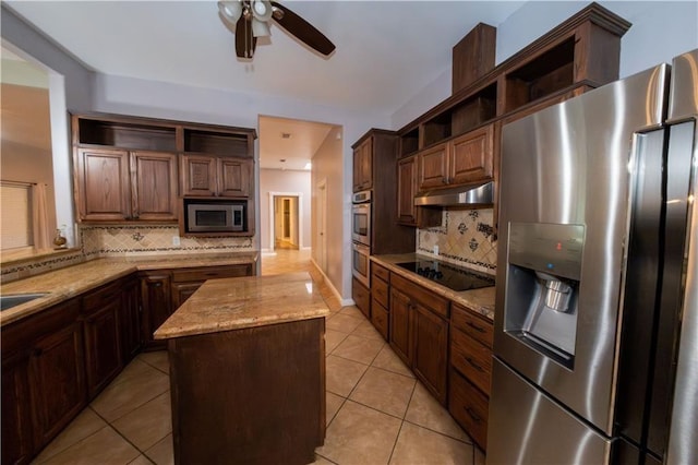 kitchen with backsplash, a kitchen island, light tile patterned floors, and stainless steel appliances