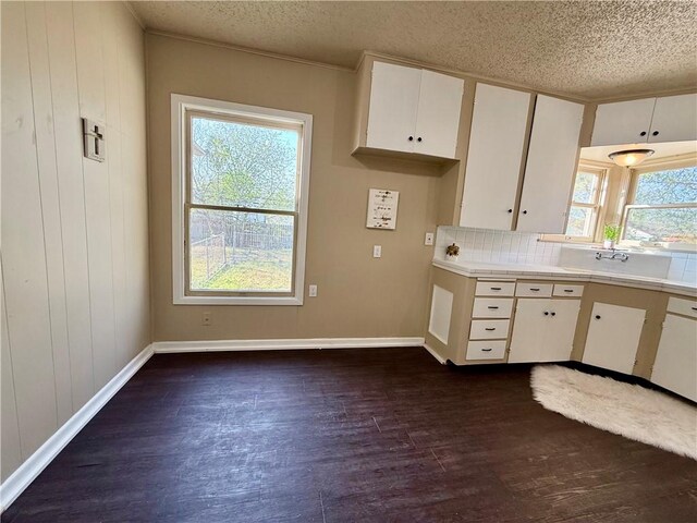 kitchen featuring tile countertops, plenty of natural light, white cabinets, and dark wood finished floors