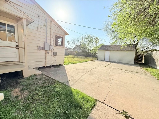 view of home's exterior with a patio, an outdoor structure, and a fenced backyard