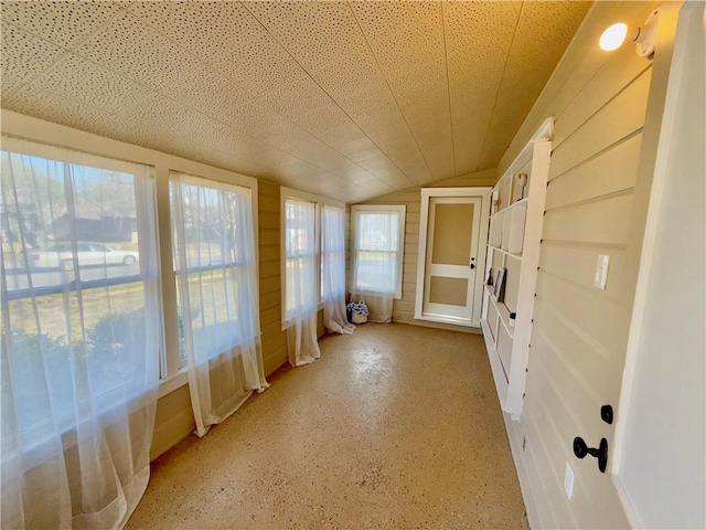 unfurnished sunroom with lofted ceiling