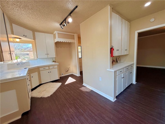 kitchen featuring white cabinetry, dark wood finished floors, and a textured ceiling