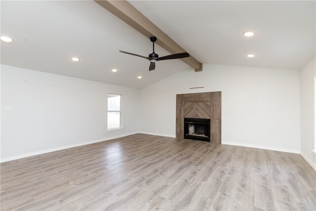 unfurnished living room featuring lofted ceiling with beams, ceiling fan, and light wood-type flooring