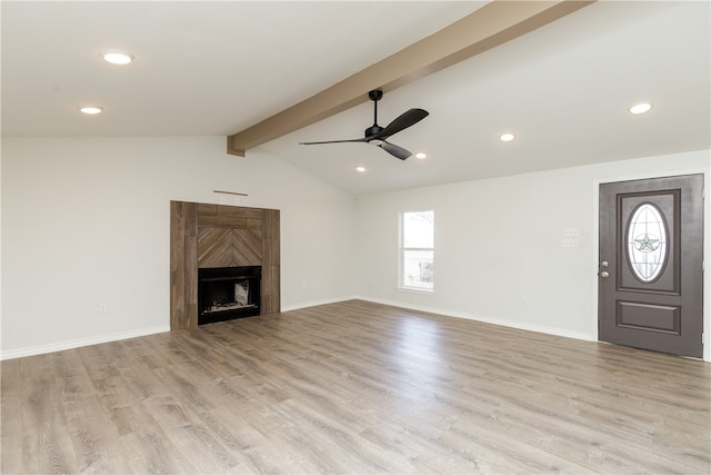 unfurnished living room featuring light wood-type flooring, ceiling fan, and vaulted ceiling with beams