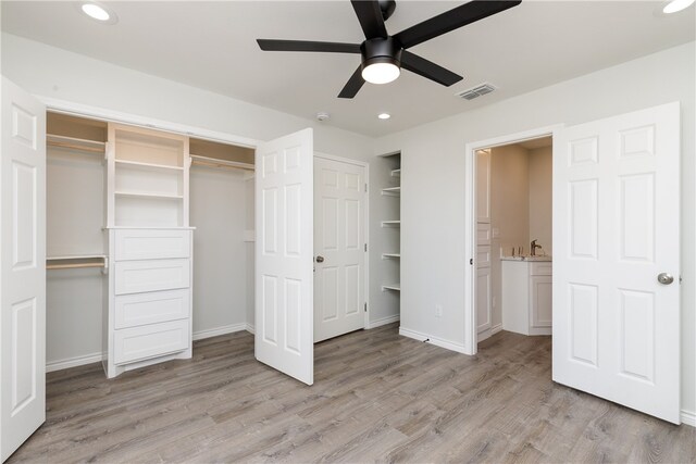 unfurnished bedroom with ceiling fan and light hardwood / wood-style flooring