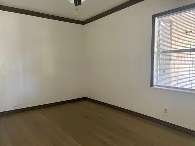 104 E Refugio St, Skidmore, TX 78389 - spare room featuring wood finished floors, crown molding, and ceiling fan