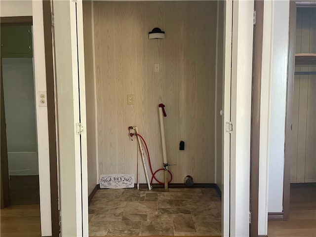104 E Refugio St, Skidmore, TX 78389 - hallway with stone finish flooring and wood walls