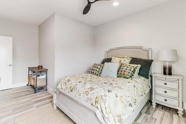 bedroom featuring wood finished floors, recessed lighting, a ceiling fan, and baseboards