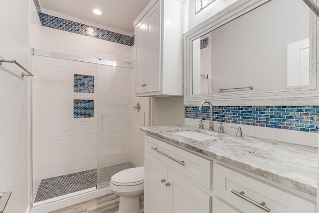 full bath with recessed lighting, backsplash, toilet, vanity, and a stall shower