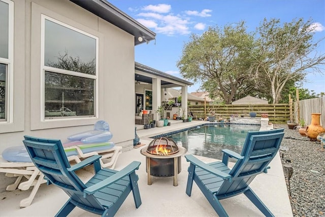 view of pool with a fire pit, a fenced backyard, a fenced in pool, and a patio area