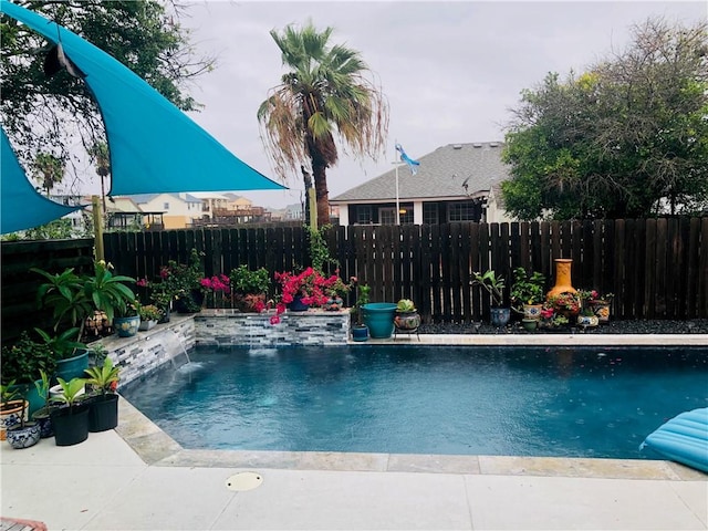 view of pool with a fenced in pool and fence