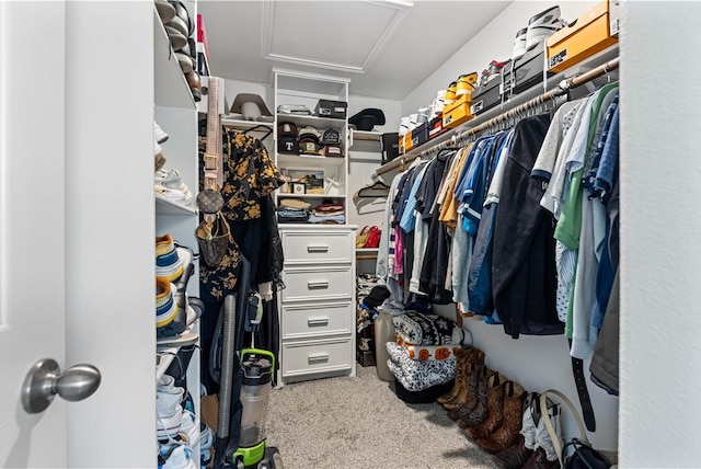 walk in closet featuring light colored carpet