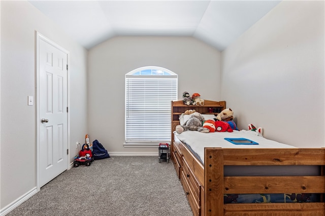 carpeted bedroom with lofted ceiling