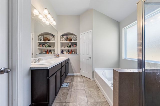 bathroom with vanity, tile patterned floors, built in shelves, and a washtub