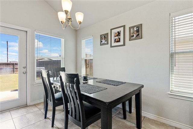 dining area featuring plenty of natural light, a notable chandelier, and light tile patterned flooring