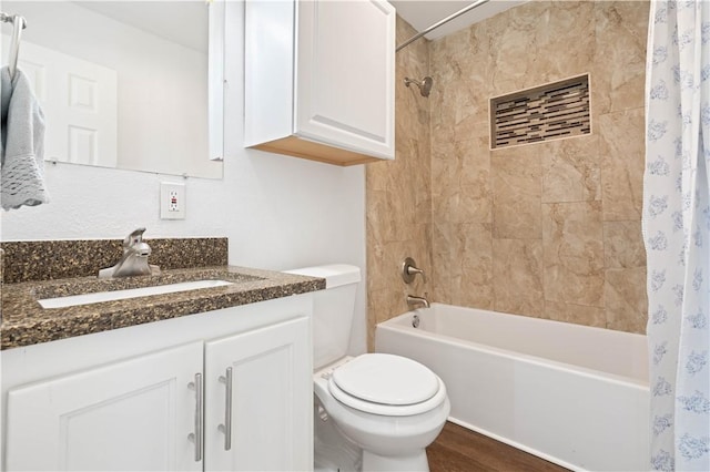 full bath with wood finished floors, shower / bath combo, vanity, and toilet