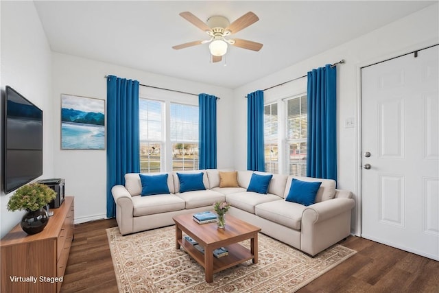 living area with dark wood-style floors and a ceiling fan