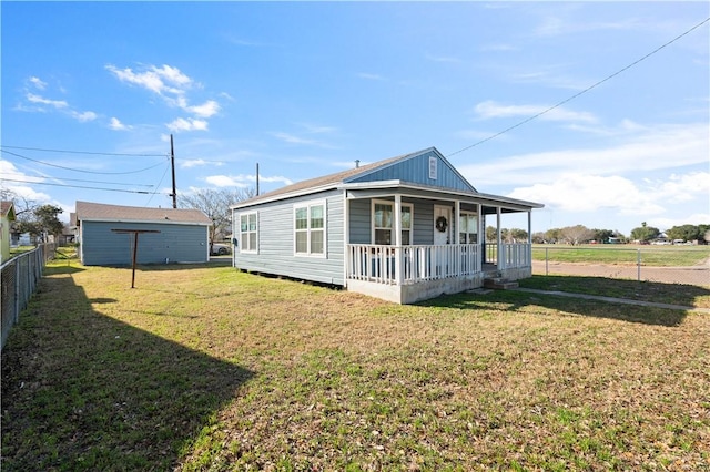 exterior space featuring a porch, a front yard, and fence