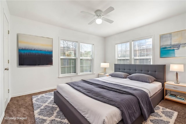 bedroom with a ceiling fan, carpet flooring, and baseboards