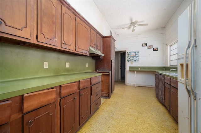 kitchen featuring ceiling fan, sink, and white refrigerator with ice dispenser