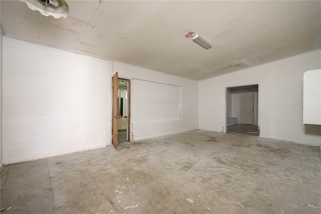 spare room with a textured ceiling