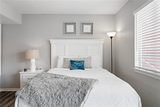 bedroom featuring dark hardwood / wood-style flooring