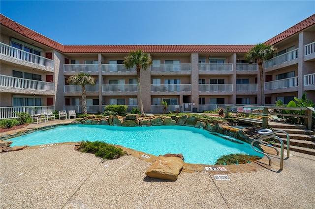 view of swimming pool with pool water feature