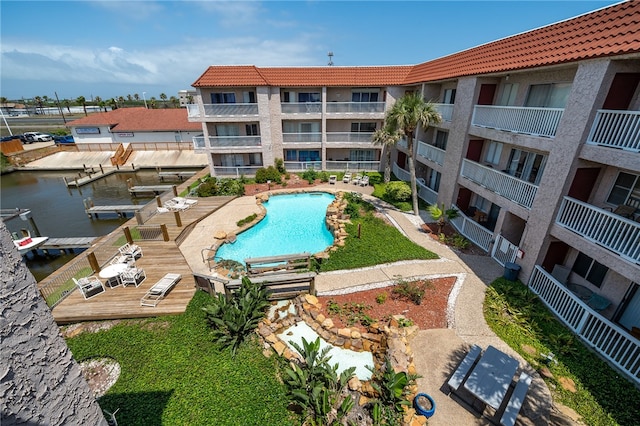 view of pool featuring a deck with water view