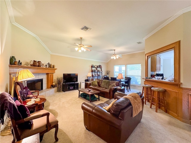 living room featuring vaulted ceiling, a tile fireplace, and ornamental molding