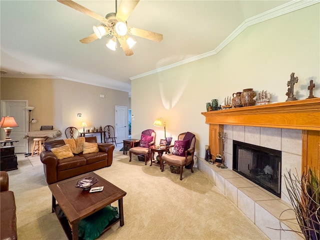 carpeted living room with ceiling fan, vaulted ceiling, ornamental molding, and a fireplace